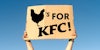 Chicken's for KFC sign in hand