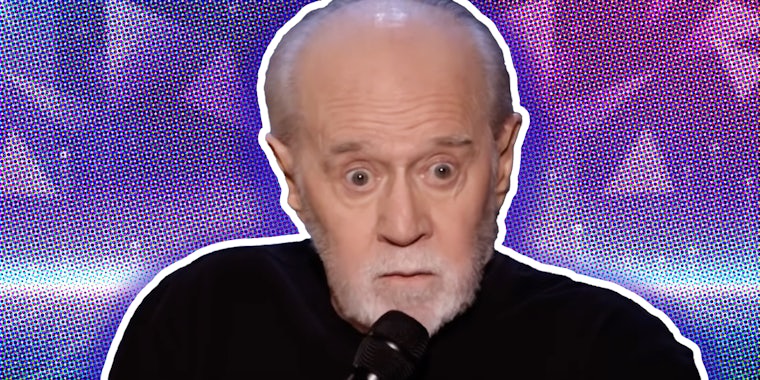George Carlin in front of abstract background